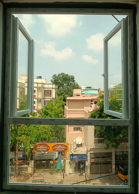 Two-sash openable uPVC window open over a city street